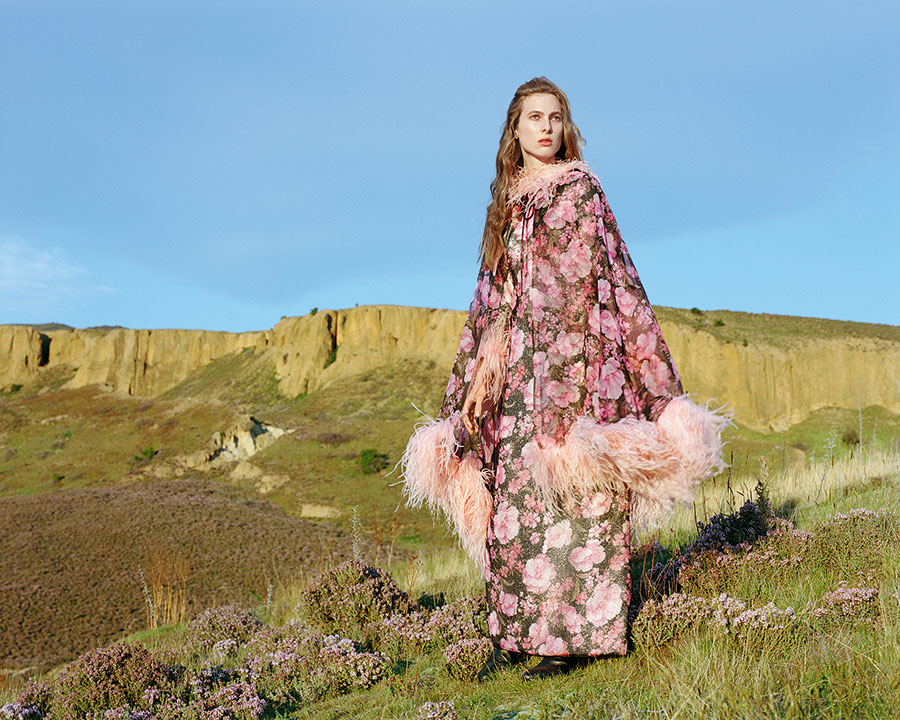Vinka Lucas (After Five) evening dress and cape, early 1970s. Lurex, printed sheer and feathers, EH60. Photographed at Bannockburn, 2019. Model: Hannah Clarke. Image supplied by Te Papa Press/Eden Hore Central Otago. Image © Derek Henderson. WORD CHCH 2025 02